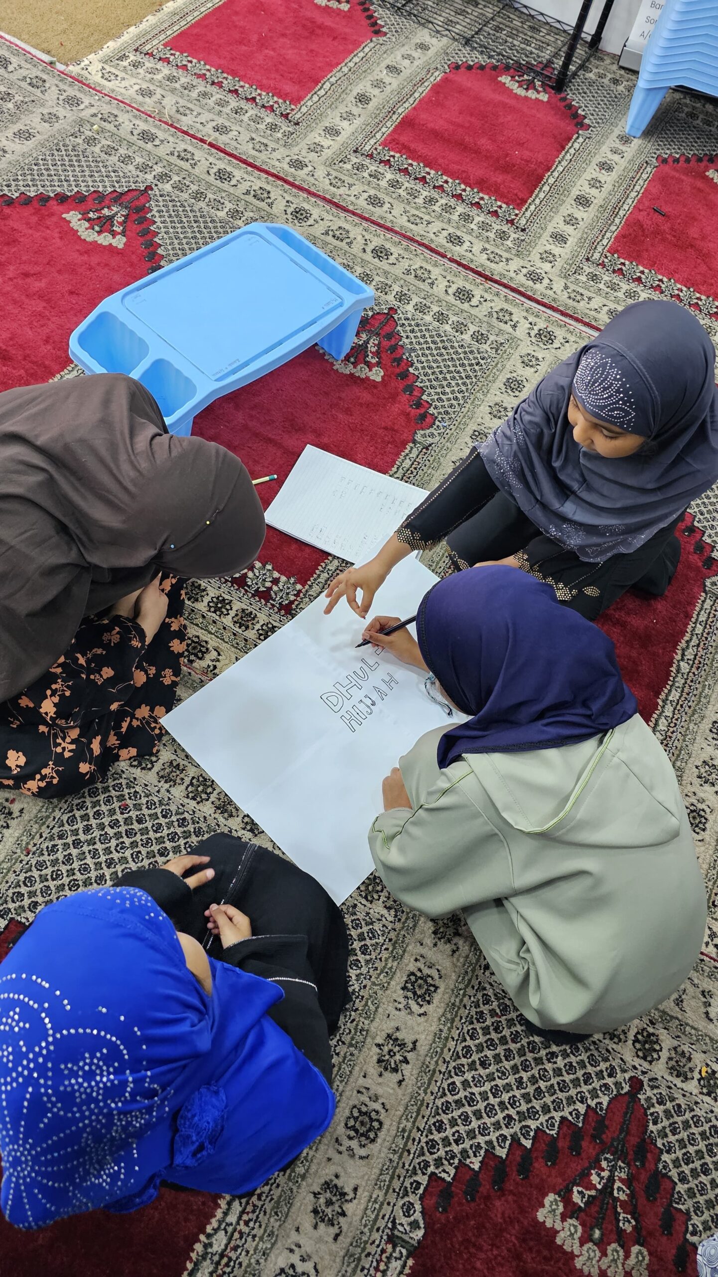A child reading with a teacher at Ummah Academy